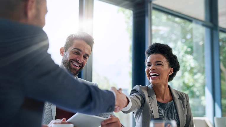 A woman shaking a mans hand